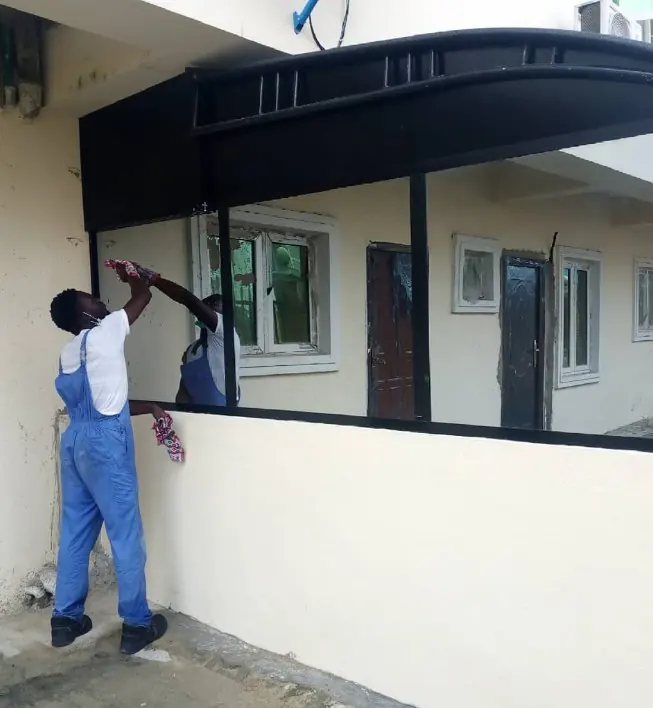 A Magnum cleaner at work: glass and frames, by hand