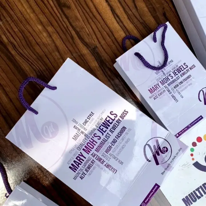 White branded paper bags with ribbon handles