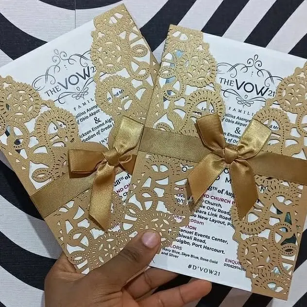 Gold lace wedding invitations with satin bows